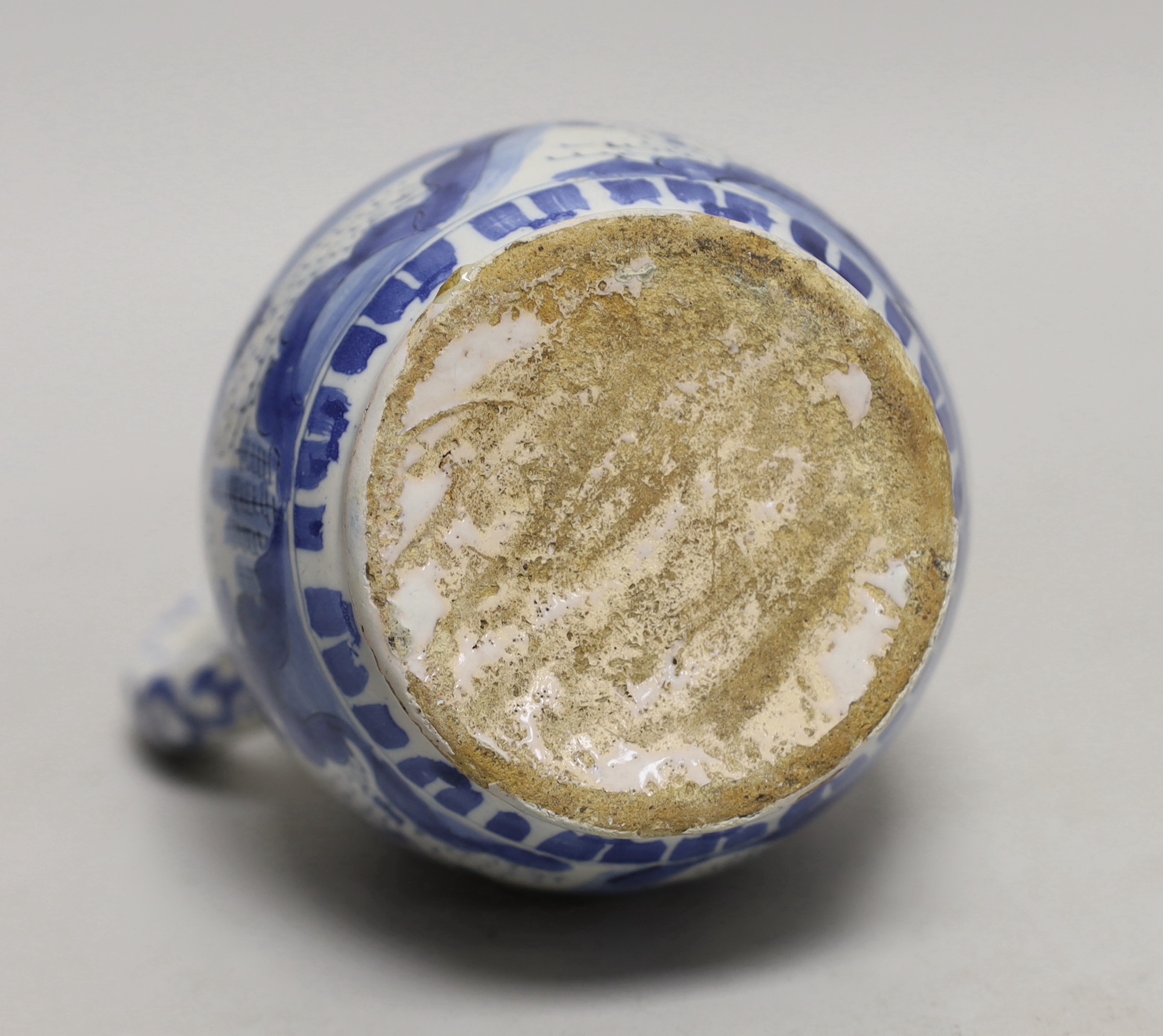 A late 17th century Delft blue and white ewer and three Chinese style tumblers and saucers, tallest 20cm